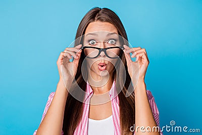 Photo of curious shocked young lady take off eyeglasses open mouth wear pink striped shirt isolated blue background Stock Photo