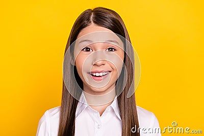 Photo of cute adorable excited schoolgirl beaming smile wear white shirt isolated yellow color background Stock Photo