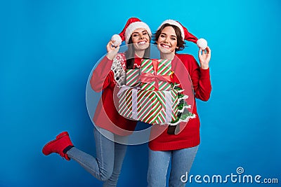 Photo of cute adorable women santa elves wear ornament pullovers packing x-mas gifts isolated blue color background Stock Photo