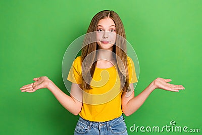 Photo of cute indifferent grimace schoolgirl teenager wear orange t-shirt hold palm dont know where stolen money Stock Photo