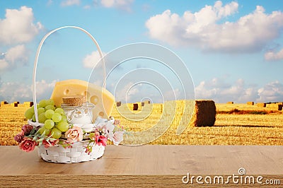 Photo of dairy products over wooden table. Symbols of jewish holiday - Shavuot Stock Photo