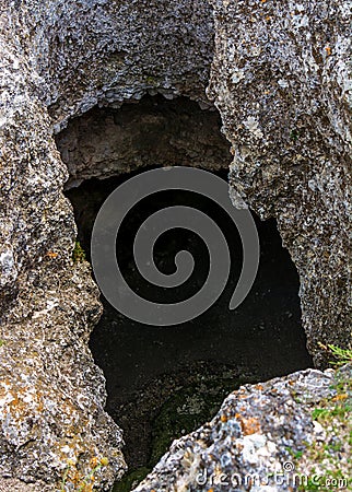 Photo of dark cave hole in the rock Stock Photo