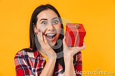 Photo of delighted young woman expressing surprise and holding gift box Stock Photo