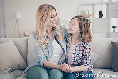 Photo of domestic attractive blond lady mommy daughter sitting comfy couch hold arms look eyes stay home quarantine Stock Photo