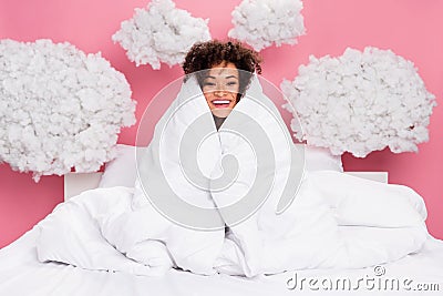 Photo of dreamy cheerful lady wear pajama sitting bed cover blanket feeling cold clouds isolated pink color background Stock Photo