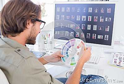 Photo editor looking at colour wheel Stock Photo