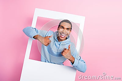 Photo of event day celebrate party funny smiling positive student man thumbs up like chilling inside paper frame Stock Photo