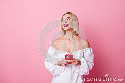 Photo of excited adorable lady wear off shoulders dress chatting instagram telegram facebook empty space isolated pink Stock Photo