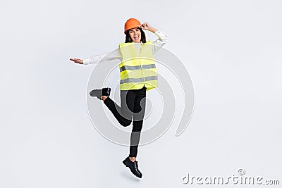 Photo of excited crazy builder lady girlish jump wear helmet shirt vest trousers shoes isolated white color background Stock Photo