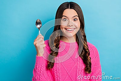 Photo of excited hungry girl dressed knit pullover holding spoon isolated blue color background Stock Photo