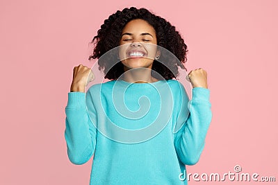 Photo of excited screaming african american young woman standing over pink background. Stock Photo