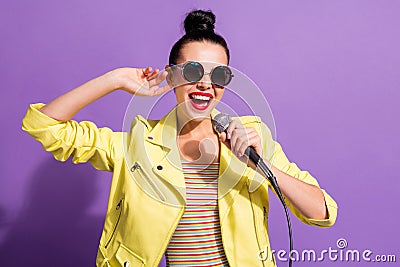 Photo of excited youth girl sing song mic karaoke over purple color background Stock Photo