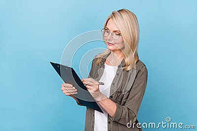 Photo of executive old lady write check list appointment reminder isolated blue pastel color background Stock Photo