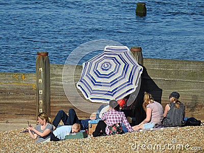 Family beach holiday fun parasol umbrella Editorial Stock Photo
