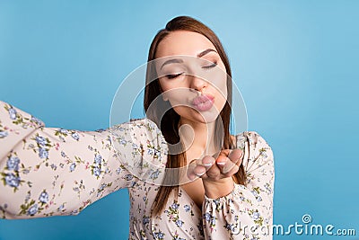 Photo of flirty brown hairdo millennial lady do selfie blow kiss wear floral blouse isolated on blue color background Stock Photo