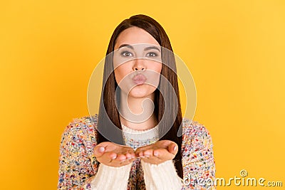 Photo of flirty charming nice young woman send air kiss young palms isolated on shine bright yellow color background Stock Photo