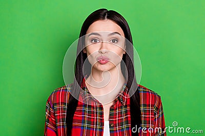 Photo of flirty straight hair young lady blow kiss wear red shirt isolated on green color background Stock Photo