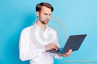 Photo of focused young man look laptop blogger work businessman concentrated face isolated on blue color background Stock Photo