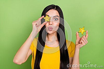 Photo of fooling impressed woman wear yellow t-shirt holding tropical fruit cover eye lips plump isolated green color Stock Photo