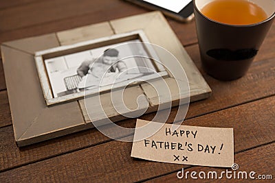Photo frame, lemon tea and card on wooden plank Stock Photo