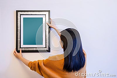 Photo Frame Mockup with Clipping Path. Woman Decorating a New Ho Stock Photo