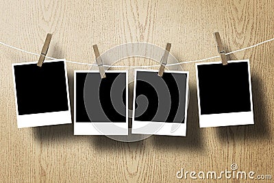 Photo frame paper attach rope on wood background Stock Photo