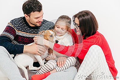 Photo of friendly family embrace each other and flatter their do Stock Photo