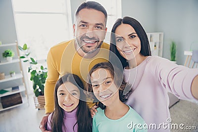 Photo of full family four people mommy take selfie hug beaming smile wear colorful sweater in living room indoors Stock Photo