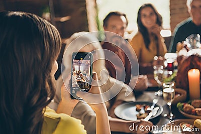 Photo of full family gathering small daughter hold telephone make adorable picture digital camera focusing push button Stock Photo