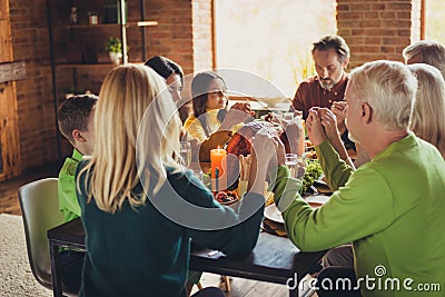 Photo of full family prayer time hold hands thanks giving dinner event homemade feast sit served table turkey living Stock Photo