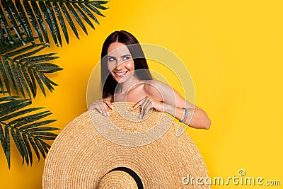 Photo of funky pretty lady wear bikini close body big sun hat looking empty space isolated yellow color background Stock Photo