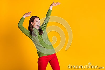 Photo of funky youngster lady dance disco hit party wear green pullover red trousers isolated yellow color background Stock Photo