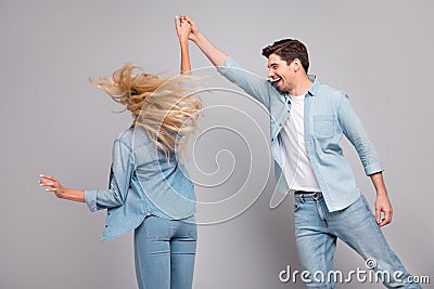 Photo of funny affectionate carefree couple dance guy spin girl wear casual jeans outfit isolated grey color background Stock Photo