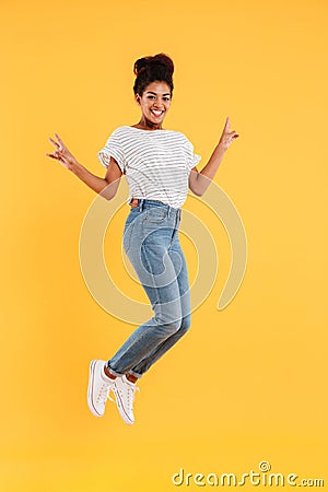 Funny african joyful lady jumping and smiling isolated Stock Photo