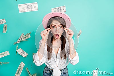 Photo of funny excited young woman dressed white shirt cap arms glasses money open mouth isolated teal color background Stock Photo