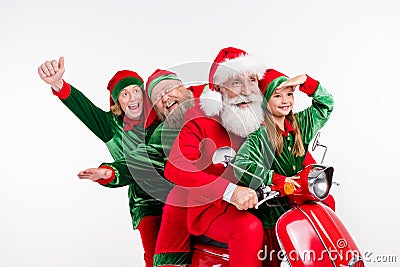 Photo of funny four people ride motorbike fast party wear santa elf costume isolated grey color background Stock Photo