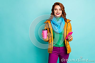 Photo of funny lady hold hot coffee mug beverage browsing telephone walk street wear casual yellow overcoat scarf pants Stock Photo