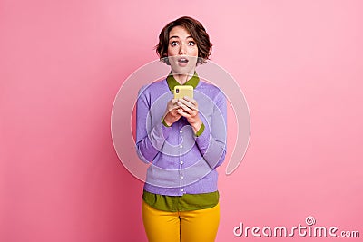 Photo of funny lady hold telephone read positive comments wear purple jumper pants isolated pink color background Stock Photo
