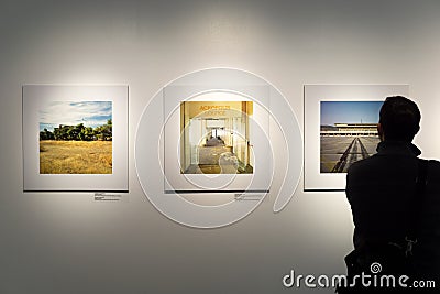 Photo gallery with a person standing Editorial Stock Photo