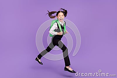 Photo of glad cheerful impressed schoolgirl jump run wear bag uniform isolated violet color background Stock Photo