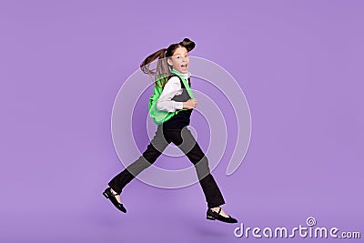 Photo of glad cheerful impressed schoolgirl jump run wear rucksack uniform isolated violet color background Stock Photo