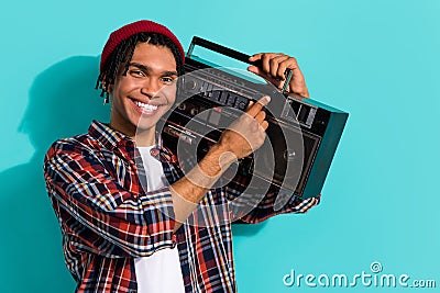 Photo of good mood guy dreadlocks wear plaid shirt make music louder hold boombox on shoulder isolated on turquoise Stock Photo