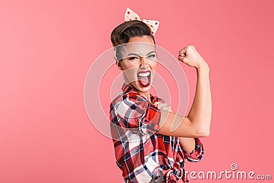 Gorgeous strong young pin-up woman showing biceps. Stock Photo