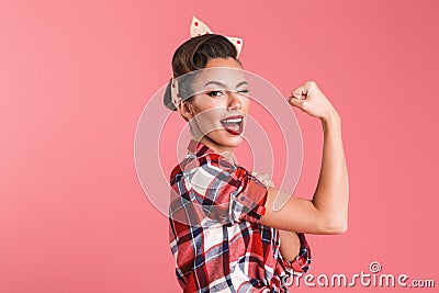 Gorgeous strong young pin-up woman showing biceps. Stock Photo