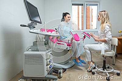 Photo of a gynecologist doctor and a patient on a gynecological chair. Preventive reception, preparation for medical Stock Photo