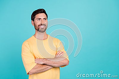 Photo of handsome brunet hair man wear yellow t shirt folded hands looking novelty plans for future isolated on cyan Stock Photo
