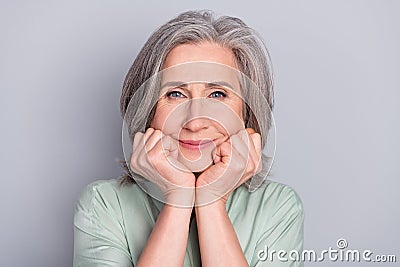 Photo of happy dreamy lovely beautiful mature woman adoring admiring relaxing isolated on grey color background Stock Photo