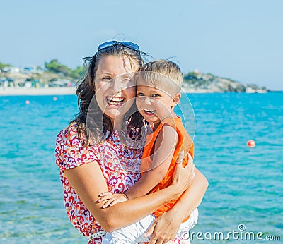 Photo of happy mother and son on the beach Stock Photo