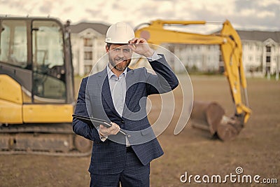 photo of happy supervisor with business project in hardhat. supervisor with business project. Stock Photo