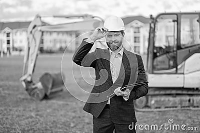 photo of happy supervisor with business project in hardhat. supervisor with business project. Stock Photo